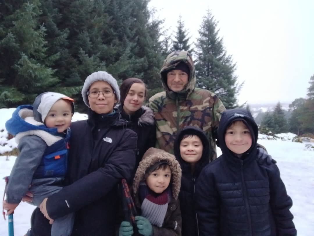 Evelyn Owens with her husband and children outdoors in the snow